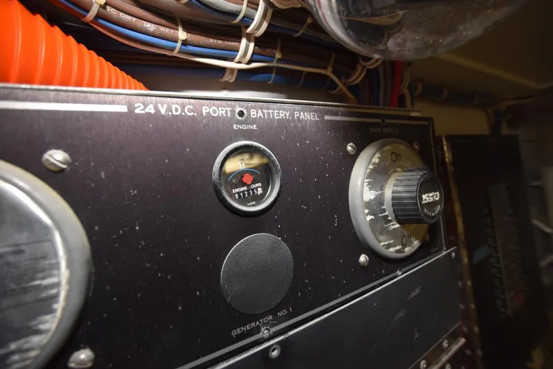 Slide: The Image of Control panel of a 1998 Hatteras 74 Sport Deck yacht, showing battery and engine gauges. - 36