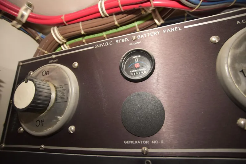 Slide: The Image of Battery panel of 1998 Hatteras 74 Sport Deck yacht with engine controls and wiring. - 38