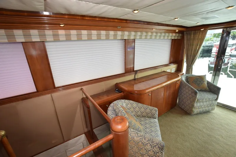 Slide: The Image of Interior of 1998 Hatteras 74 Sport Deck yacht with elegant wood finish and seating area. - 13