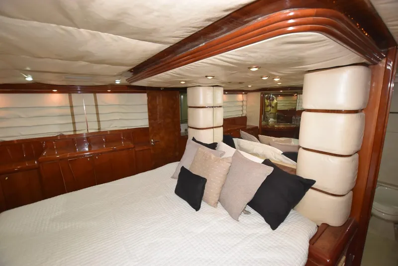 Slide: The Image of Luxurious bedroom interior of 1998 Hatteras 74 Sport Deck yacht with elegant wood finish. - 15