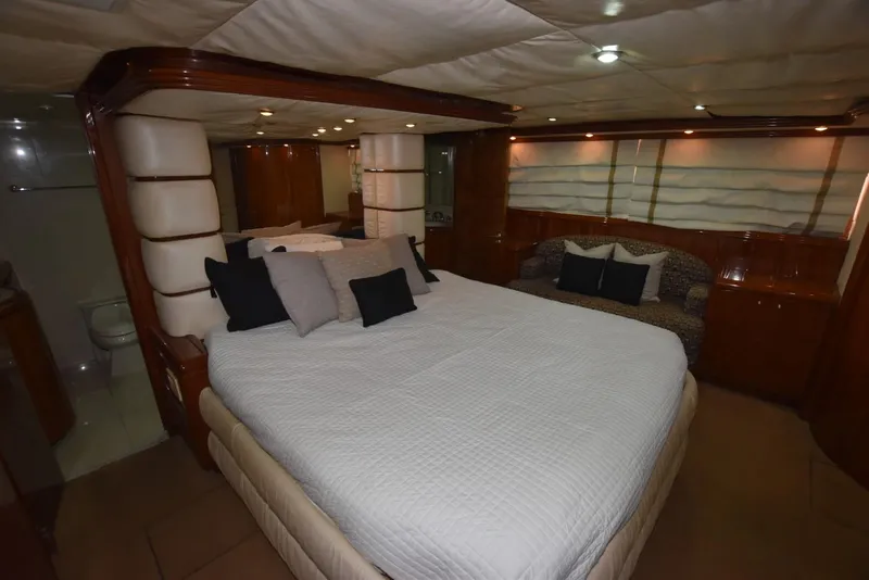 Slide: The Image of Luxurious bedroom interior of 1998 Hatteras 74 Sport Deck yacht with elegant furnishings. - 16