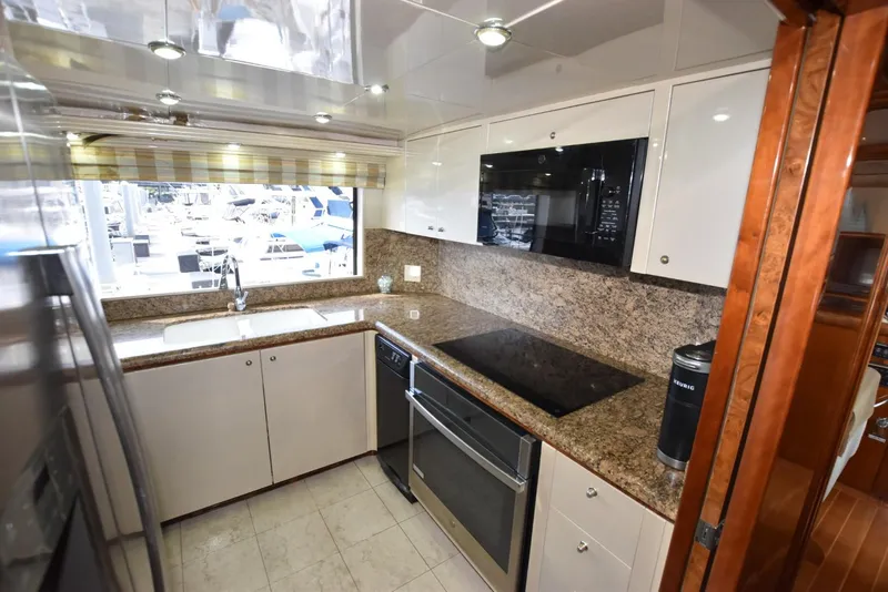 Slide: The Image of Modern kitchen in 1998 Hatteras 74 Sport Deck yacht with granite countertops and stainless steel appliances. - 21