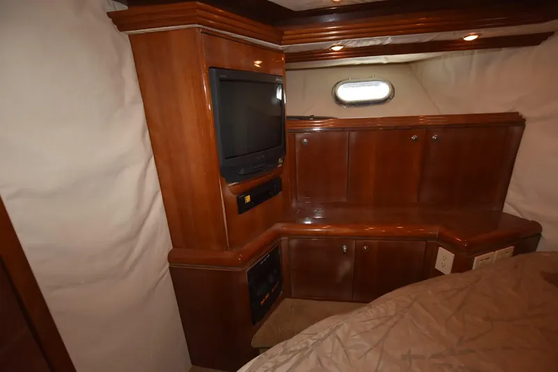 Slide: The Image of Interior of 1998 Hatteras 74 Sport Deck yacht with wood cabinetry and TV. - 32