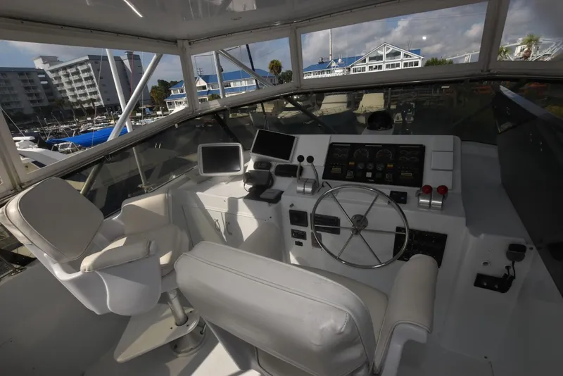 Slide: The Image of Helm of 1998 Hatteras 74 Sport Deck yacht with steering wheel and navigation equipment. - 4