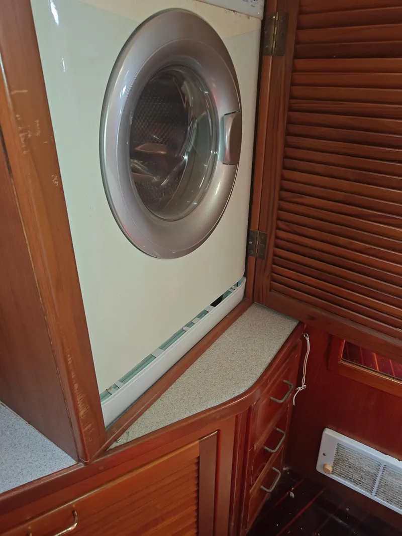 Slide: The Image of Washing machine in a 1994 Catalina Morgan boat interior with wooden cabinetry. - 12