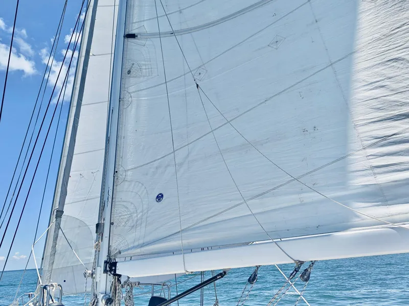 Slide: The Image of Sailing yacht with white sails, Catalina Morgan 1994, against a clear blue sky. - 16