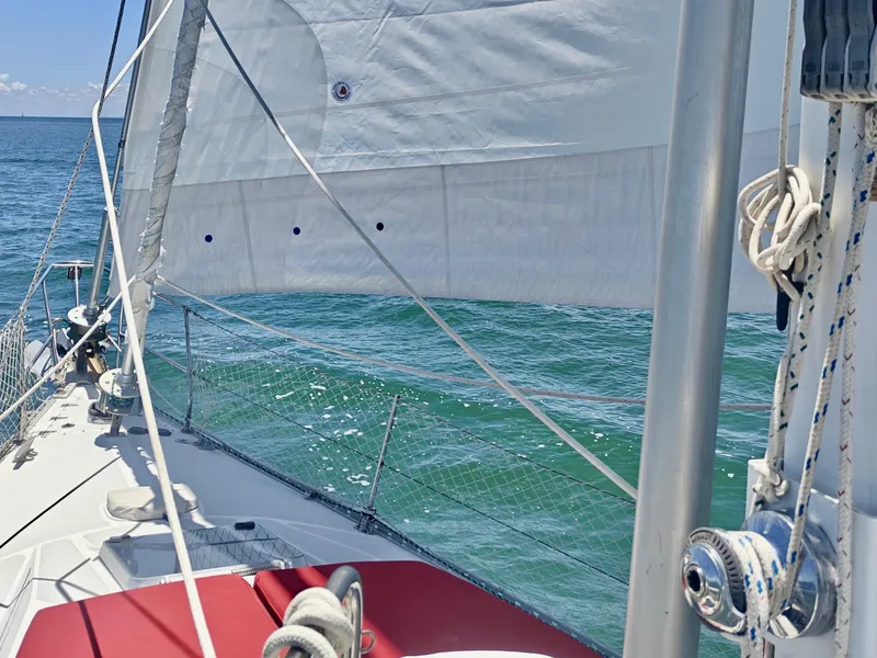 Slide: The Image of Sailing on a 1994 Catalina Morgan yacht with white sails over blue ocean waters. - 18