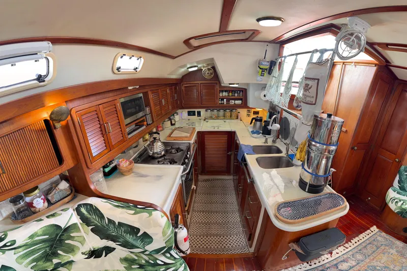 Slide: The Image of Cozy 1994 Catalina Morgan yacht kitchen with wooden cabinets and modern appliances. - 30