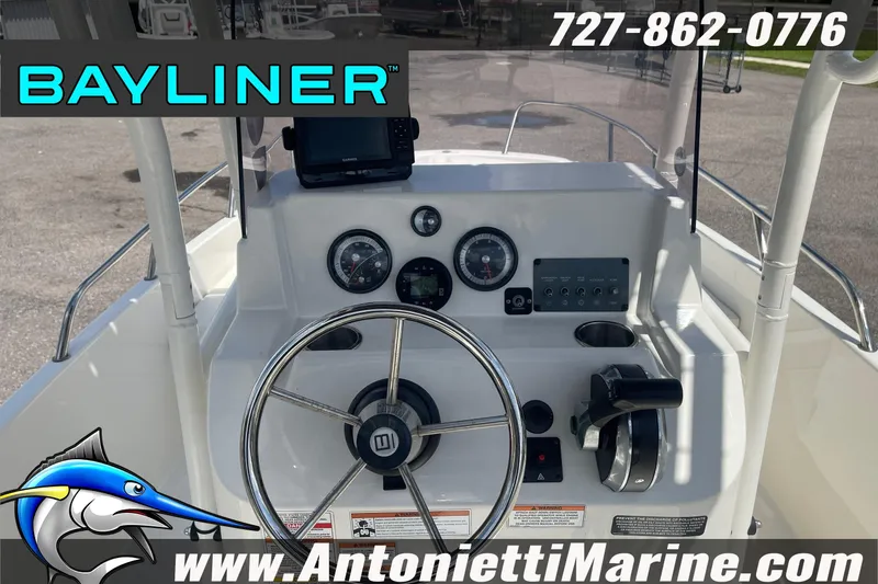 Slide: The Image of 2020 Bayliner Element F21 boat dashboard with steering wheel and controls. - 12