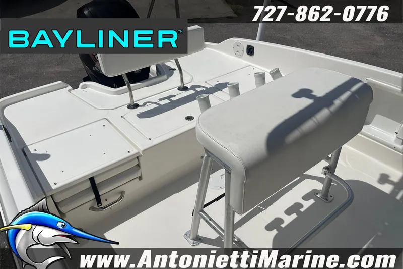 Slide: The Image of 2020 Bayliner Element F21 boat interior with seating and storage compartments. - 17