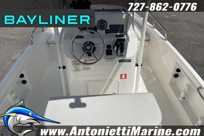 Slide: The Image of 2020 Bayliner Element F21 boat interior with steering wheel and controls, Antonietti Marine branding. - 2