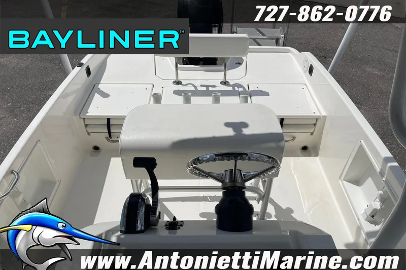 Slide: The Image of 2020 Bayliner Element F21 boat interior with steering wheel and seating, Antonietti Marine branding. - 3