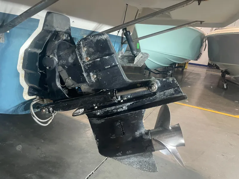 Slide: The Image of 1993 Regal Ambassador 233 boat propeller and stern drive in a garage setting. - 12