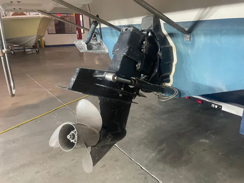 Slide: The Image of 1993 Regal Ambassador 233 boat propeller and outdrive in a garage setting. - 13