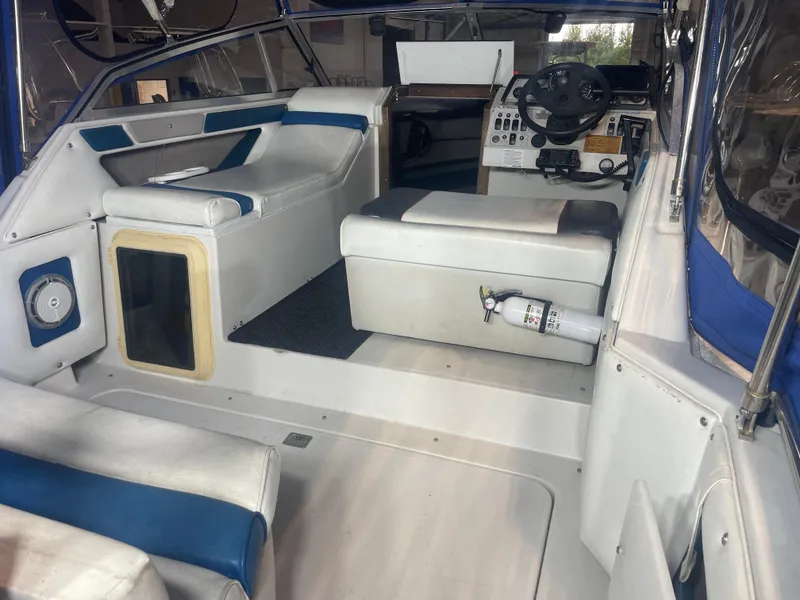Slide: The Image of Interior of a 1993 Regal Ambassador 233 boat with seating and steering area. - 17