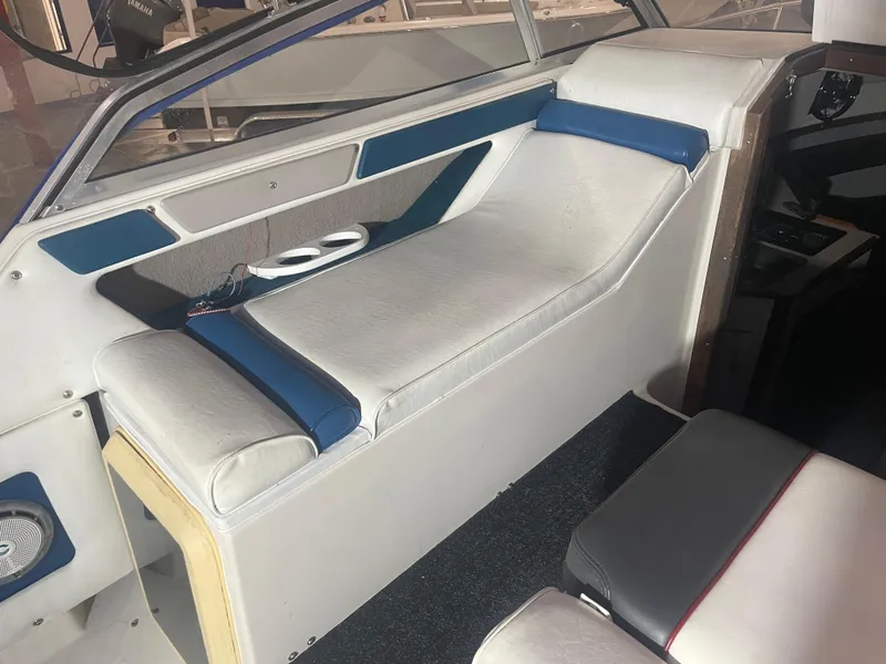 Slide: The Image of Interior of a 1993 Regal Ambassador 233 boat with white and blue seating. - 19