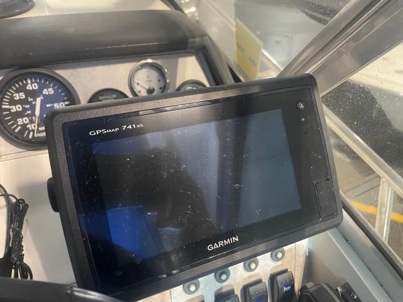 Slide: The Image of Garmin GPSMAP 741xs on 1993 Regal Ambassador 233 dashboard with gauges. - 23