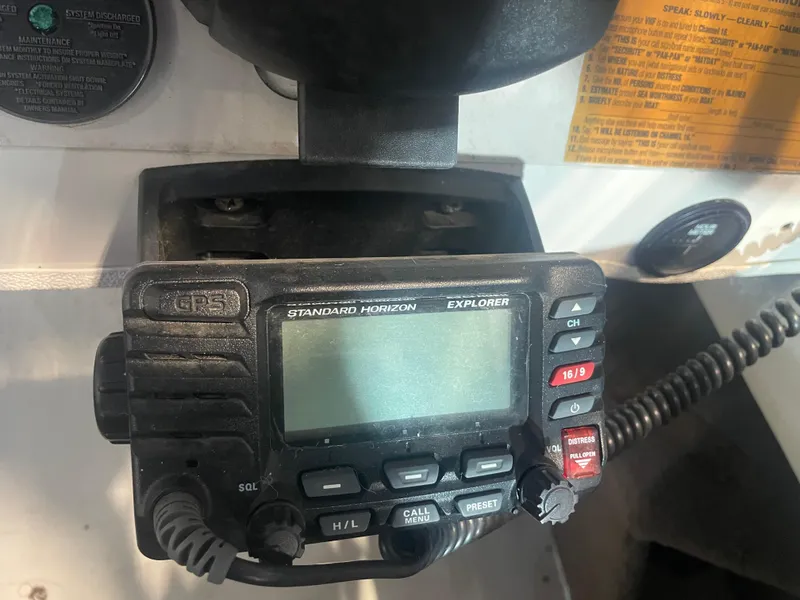 Slide: The Image of Standard Horizon Explorer radio on 1993 Regal Ambassador 233 boat dashboard. - 24