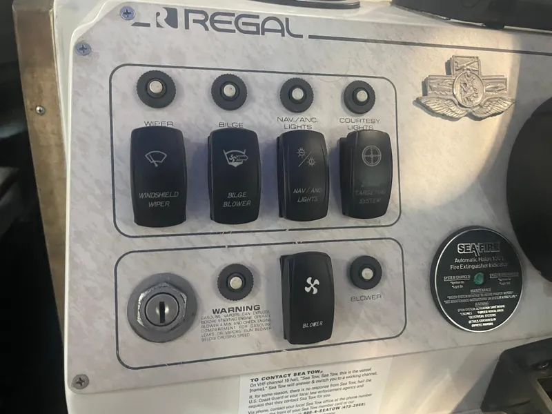 Slide: The Image of Control panel of a 1993 Regal Ambassador 233 boat with various switches and labels. - 26
