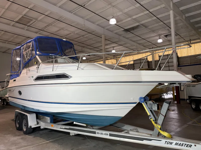 Slide: The Image of 1993 Regal Ambassador 233 boat on trailer in indoor storage facility. - 3