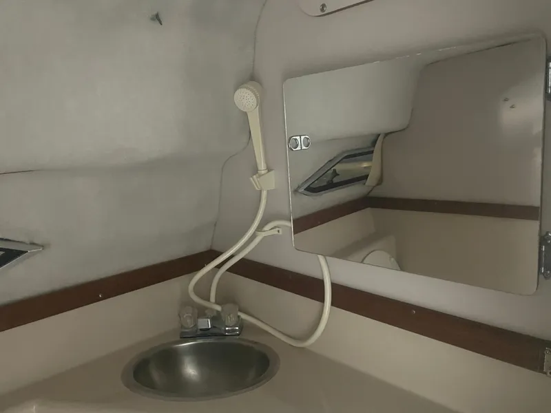 Slide: The Image of Interior of 1993 Regal Ambassador 233 boat with sink and mirror. - 33