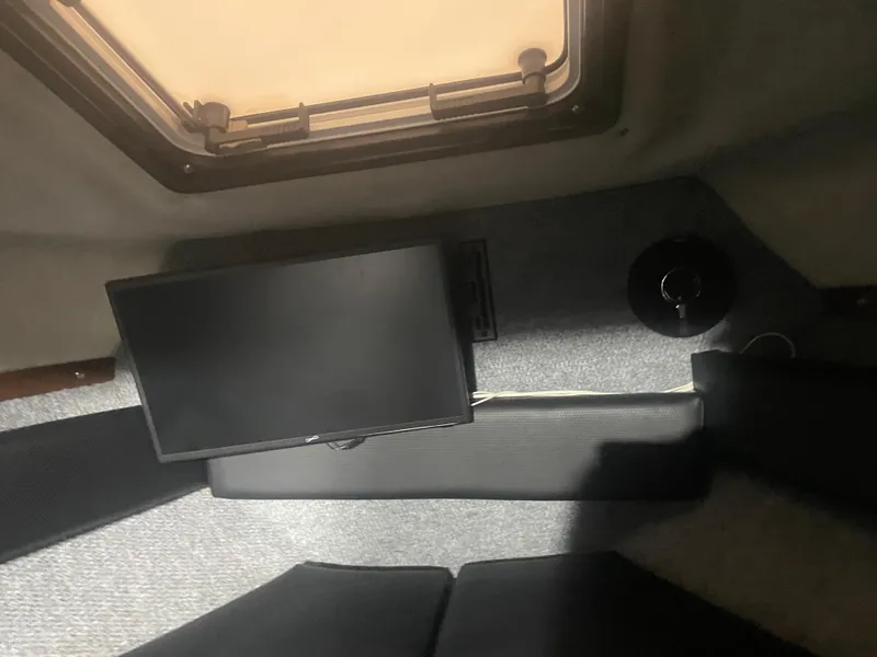 Slide: The Image of Interior of 1993 Regal Ambassador 233 boat with TV and hatch window. - 34