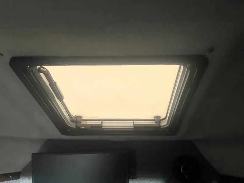 Slide: The Image of Interior view of a 1993 Regal Ambassador 233 boat hatch window. - 35
