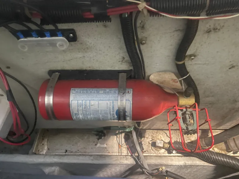 Slide: The Image of Fire extinguisher mounted in a 1993 Regal Ambassador 233 boat engine compartment. - 42