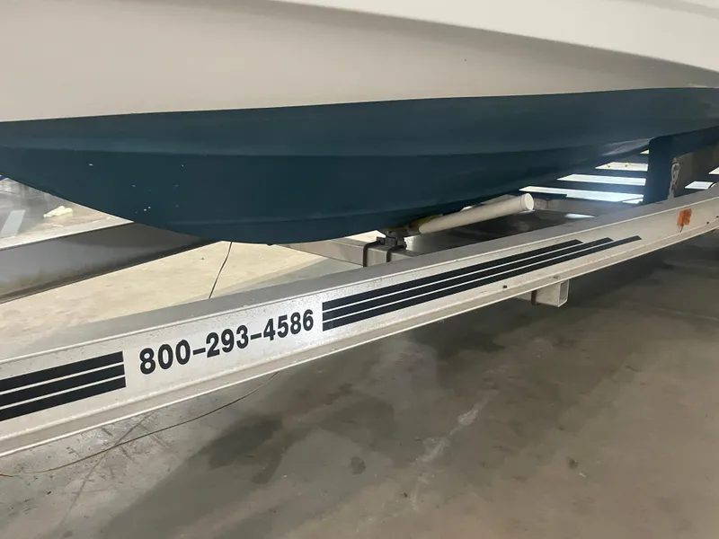Slide: The Image of Trailer with Regal Ambassador 233 boat, 1993 model, contact number visible. - 46