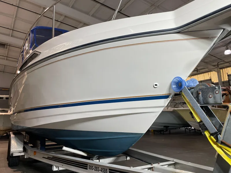 Slide: The Image of 1993 Regal Ambassador 233 boat on trailer in indoor storage facility. - 8