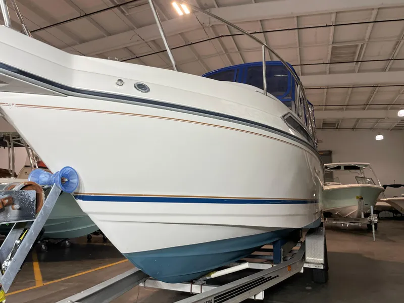 Slide: The Image of 1993 Regal Ambassador 233 boat on trailer in indoor storage facility. - 9