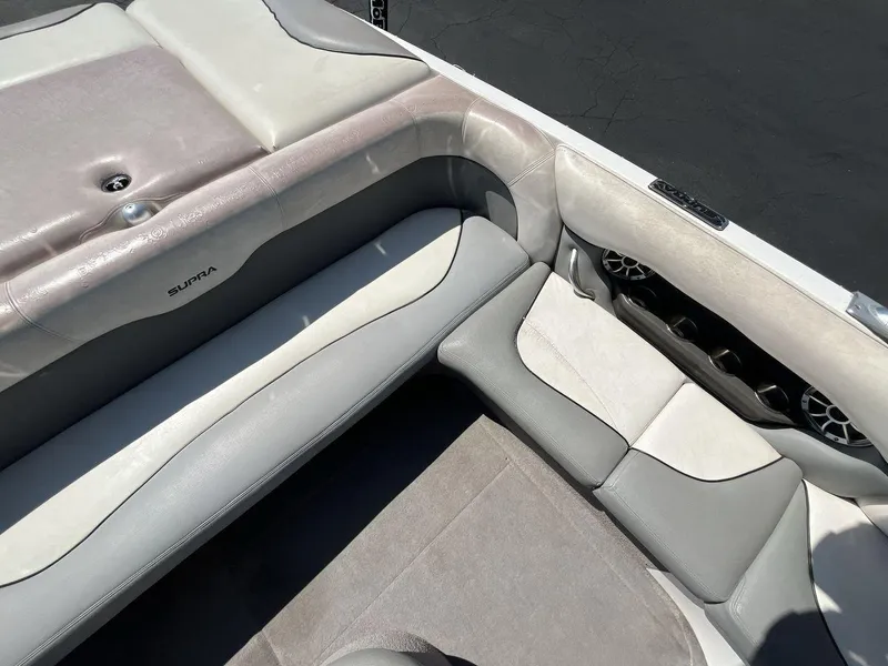 Slide: The Image of 2009 Supra Launch 24 SSV boat interior with gray and white seating. - 10