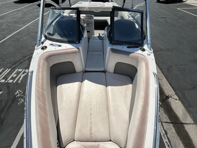 Slide: The Image of 2009 Supra Launch 24 SSV boat interior with beige seating and open windshield. - 12