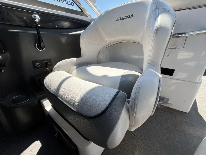 Slide: The Image of 2009 Supra Launch 24 SSV boat seat, gray and white upholstery, interior view. - 13
