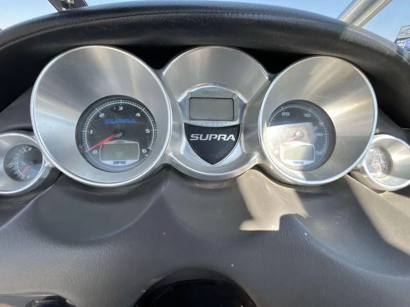 Slide: The Image of Dashboard of a 2009 Supra Launch 24 SSV boat with gauges and controls. - 15