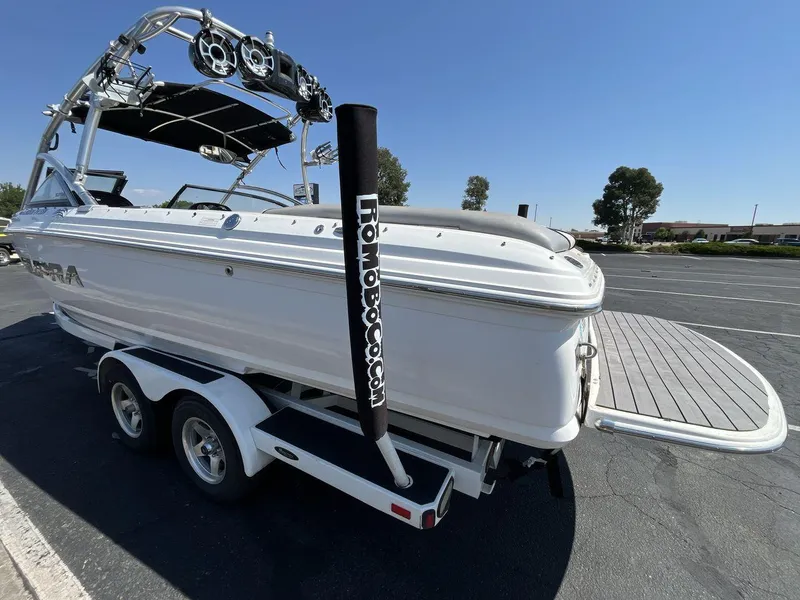 Slide: The Image of 2009 Supra Launch 24 SSV boat on trailer, rear view, sunny day. - 3