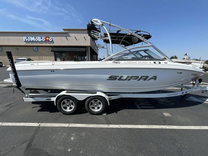 Slide: The Image of 2009 Supra Launch 24 SSV boat on trailer in parking lot. - 6