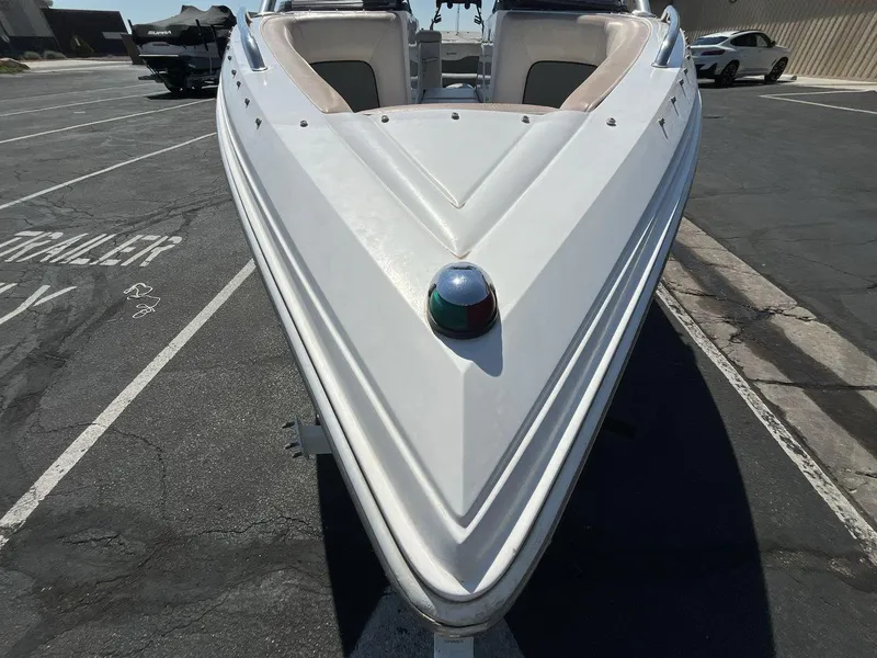 Slide: The Image of 2009 Supra Launch 24 SSV boat parked in a lot, front view. - 8
