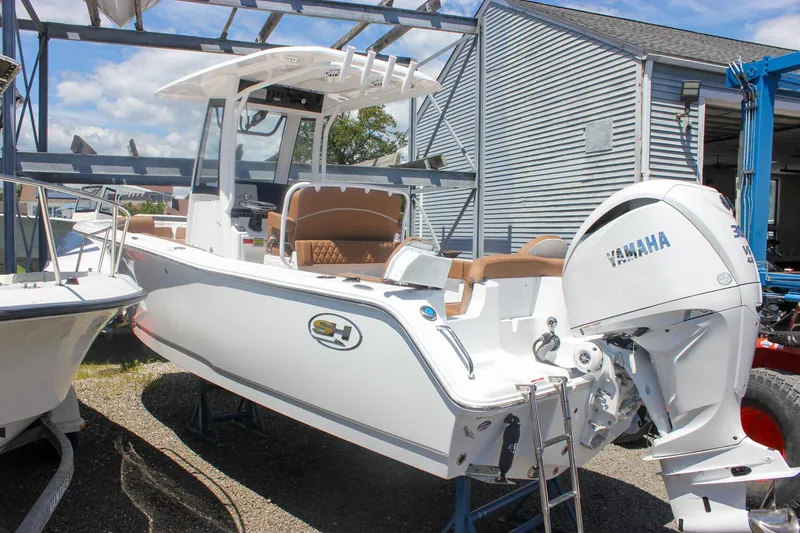 The Image of 2026 Sea Hunt Ultra 245 SE boat with Yamaha engine, docked outdoors. - 0