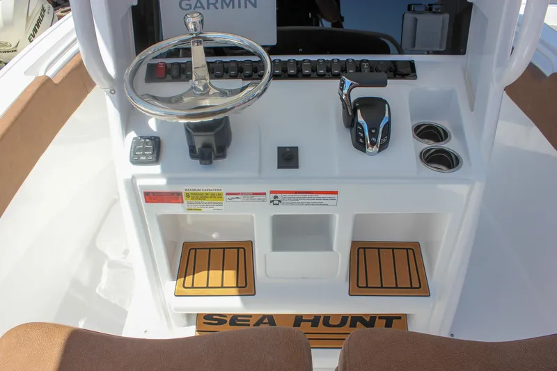 Slide: The Image of 2026 Sea Hunt Ultra 245 SE boat console with steering wheel, controls, and Garmin display. - 10