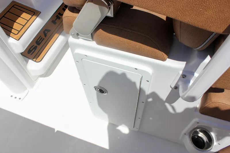 Slide: The Image of Interior view of 2026 Sea Hunt Ultra 245 SE boat, featuring seating and storage compartment. - 14