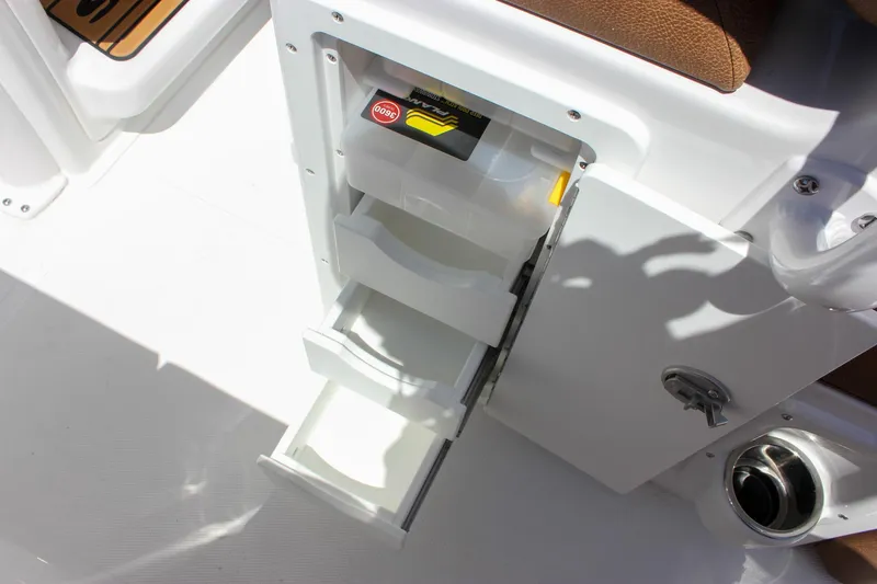 Slide: The Image of Storage compartment on 2026 Sea Hunt Ultra 245 SE boat with open drawers. - 15