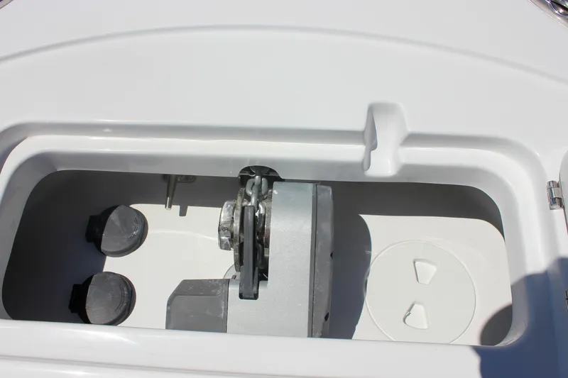Slide: The Image of Anchor compartment of 2026 Sea Hunt Ultra 245 SE boat, featuring storage and mechanical components. - 18