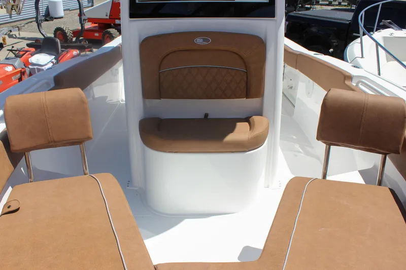 Slide: The Image of Interior view of 2026 Sea Hunt Ultra 245 SE boat with brown seating. - 19