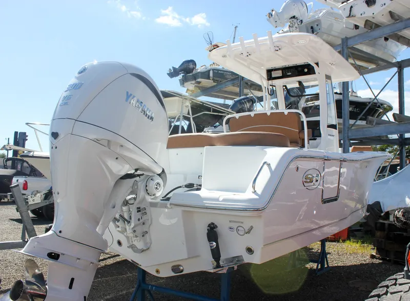 Slide: The Image of 2026 Sea Hunt Ultra 245 SE boat with Yamaha outboard motor, displayed outdoors. - 27