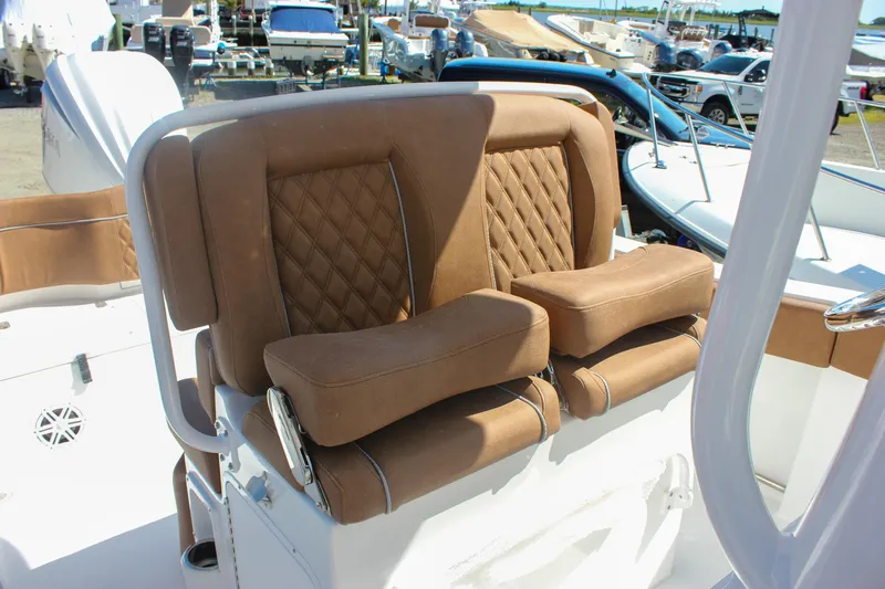 Slide: The Image of Luxurious seating on 2026 Sea Hunt Ultra 245 SE boat, featuring tan upholstery and diamond stitching. - 30
