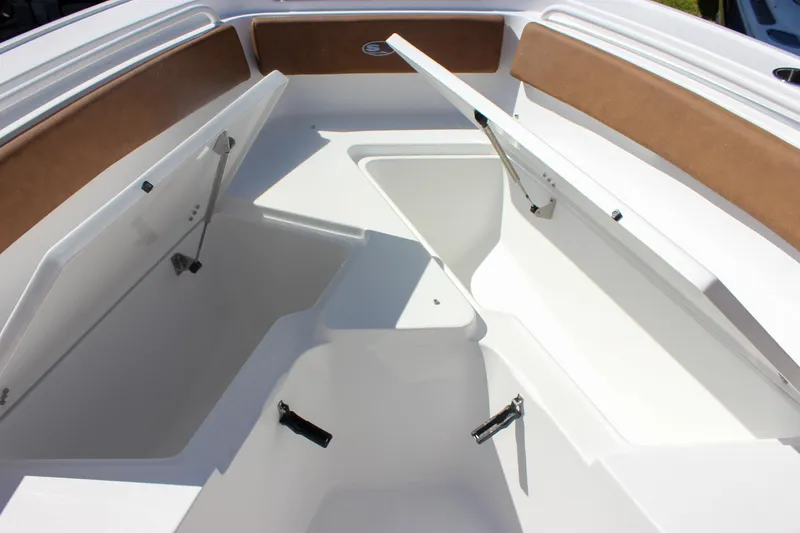 Slide: The Image of 2026 Sea Hunt Ultra 245 SE boat storage compartments with open hatches and cushioned seating. - 33