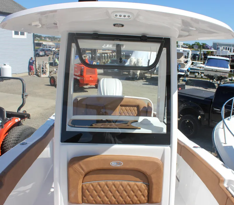 Slide: The Image of 2026 Sea Hunt Ultra 245 SE boat console with brown leather accents and modern design. - 35