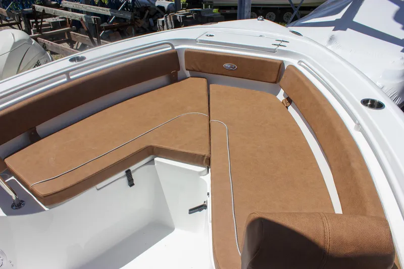 Slide: The Image of 2026 Sea Hunt Ultra 245 SE boat with brown cushioned seating in the bow area. - 7