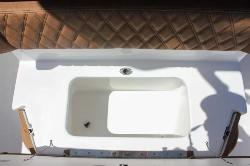 Slide: The Image of 2026 Sea Hunt Ultra 245 SE boat interior with cushioned seating and storage compartment. - 9